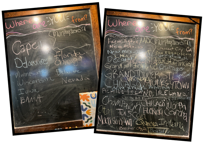 Four chalkboards filled with signatures of visitors from dozens of cities and countries duing the eclipse